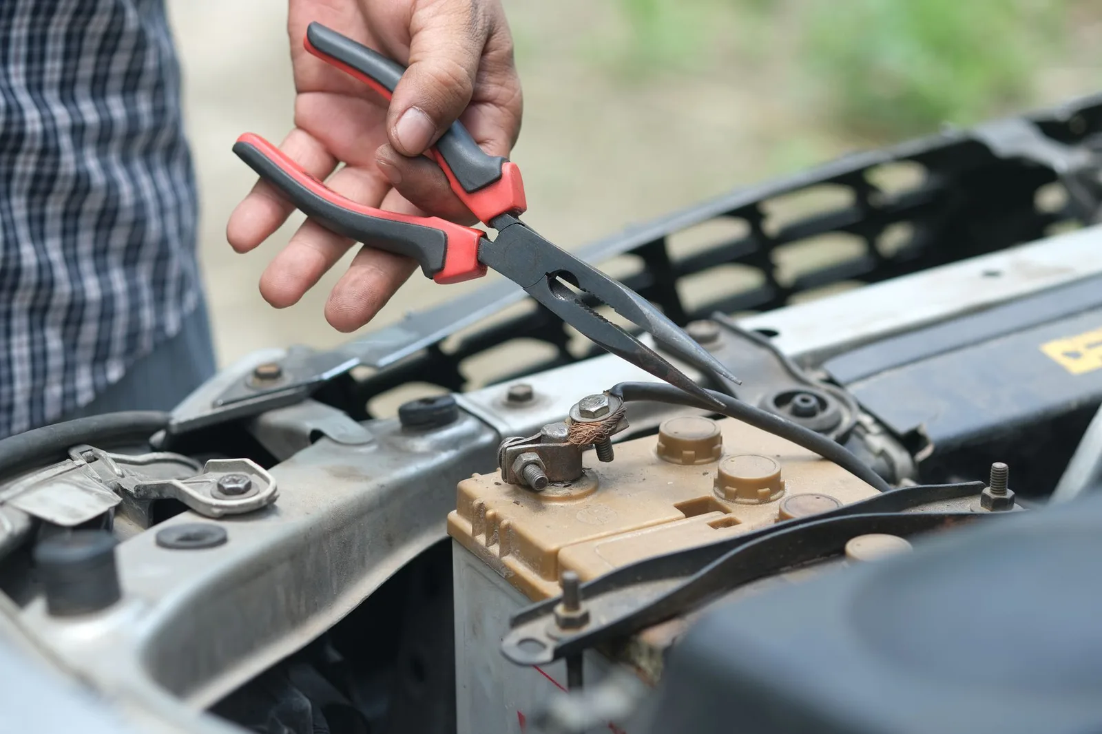 Technician testing and replacing a commercial truck battery